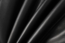 Cargar imagen en el visor de la galería, Close-up of smooth black lambskin leather texture, showcasing the soft finish and high-quality material of a leather jacket.