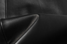 Cargar imagen en el visor de la galería, Close-up of black lambskin leather fabric on a REED Men's Jacket, showcasing its smooth and soft texture.