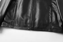 Load image into Gallery viewer, Close-up of black REED men's lambskin leather jacket, featuring stand-up collar and front zip-up closure.