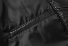 Load image into Gallery viewer, Close-up of genuine lambskin leather texture on REED men's jacket with zipper detail, showcasing luxury quality.
