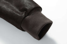 Load image into Gallery viewer, Close-up of sleeve cuff on REED Men's Baseball Suede Leather Jacket, showcasing smooth texture and ribbed design.