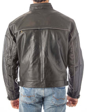 Charger l'image dans la galerie, Back view of a black vented leather motorcycle jacket with light reflector, featuring adjustable straps and air vents, worn by a model.