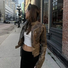 Charger l'image dans la galerie, Woman wearing a vintage zip-up faux leather jacket in a city street, showcasing vegan leather with urban and timeless style.