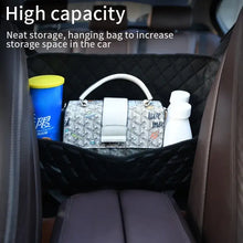 Cargar imagen en el visor de la galería, Luxury leather car handbag holder organizer between seats with a white handbag and bottles, showcasing high capacity storage solution.