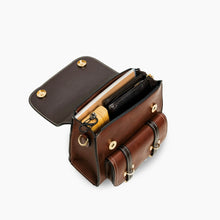 Load image into Gallery viewer, Interior view of Bumblebee vegan leather backpack with compartments holding various items like a notebook, wallet, and umbrella.