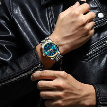 Load image into Gallery viewer, Man wearing luxury watch with blue dial and two-tone band, pairing with a black leather jacket for an elegant style statement.