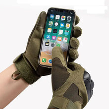 Load image into Gallery viewer, Person wearing tactical military gloves using a smartphone, showcasing rugged design and touchscreen functionality.