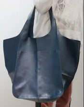 Cargar imagen en el visor de la galería, Vegan leather shoulder bag in navy blue, casual PU tote for everyday use, shown held against a light background.