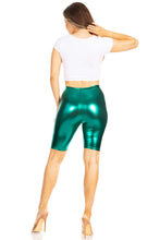 Cargar imagen en el visor de la galería, Woman wearing shiny metallic green bike shorts, showcasing the stretchy, unisex design made in USA.