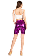 Cargar imagen en el visor de la galería, Purple shiny metallic bike shorts, stretchy unisex fit, worn by model, made in USA, featuring elastic waistband and mid-length design.
