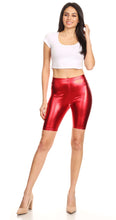 Cargar imagen en el visor de la galería, Shiny metallic red bike shorts with stretchy fit, unisex design, modeled by a person wearing a white top and heels. Made in USA.