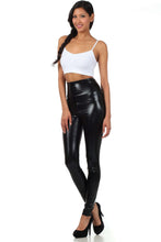 Cargar imagen en el visor de la galería, Model wearing shiny liquid metallic high waist stretch leggings, black, designed and made in USA, paired with white top and heels.
