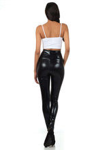 Cargar imagen en el visor de la galería, Woman wearing shiny black high waist metallic leggings with a white top, showcasing back view. Perfect fit, made in USA.