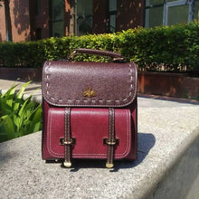 Load image into Gallery viewer, Bumblebee vegan leather backpack in the sun, showcasing maroon color and elegant design for professionals.