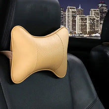 Cargar imagen en el visor de la galería, PU leather car neck pillow on car seat, providing head pain relief and comfort during drives with stylish and functional design.