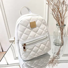 Cargar imagen en el visor de la galería, White quilted mini backpack for women, PU leather, multifunctional crossbody bag on glass surface next to decorative branches.