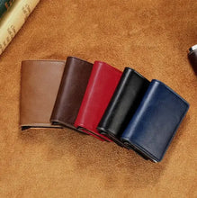 Cargar imagen en el visor de la galería, Assorted Hold Anti-Theft Leather Wallets with RFID/NFC Protection in brown, red, black, and blue on a leather background.