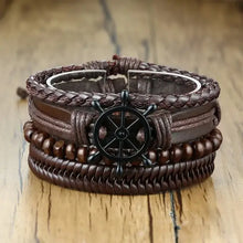 Cargar imagen en el visor de la galería, Vnox 4-piece braided vegan leather wrap bracelets with zinc alloy accents and lace-up clasp on wood surface.