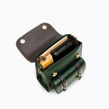 Load image into Gallery viewer, Open green vegan leather backpack showing organized compartments with accessories inside.