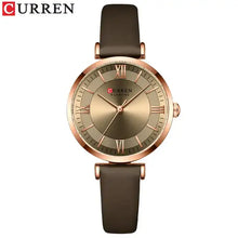 Cargar imagen en el visor de la galería, Classic Clock Leather Watch for women with brown leather strap and gold-tone clockface, featuring quartz movement and water resistance.