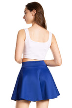 Load image into Gallery viewer, Woman wearing a blue flared mini skater skirt with white tank top, showcasing stylish casual fashion made in USA.