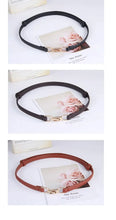 Cargar imagen en el visor de la galería, Three adjustable leather dress belts in black, brown, and tan displayed with a floral card background.