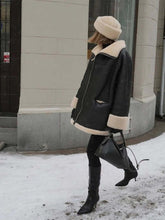 Load image into Gallery viewer, Woman wearing Cozy Chic Bomber Jacket with faux wool patchwork and fur liner, standing on snowy street stylishly dressed in winter fashion.