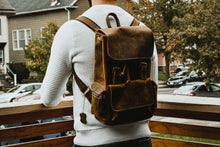 Charger l'image dans la galerie, The Hagen Backpack | Vintage Leather Backpack showcased in outdoor setting, emphasizing genuine cowhide leather quality and style.