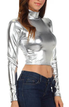 Load image into Gallery viewer, Metallic liquid mock neck turtleneck crop top, long sleeve, shining silver color, modeled with blue jeans, made in USA.