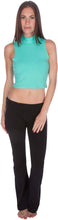 Charger l'image dans la galerie, Model wearing aqua mock neck sleeveless scuba crop top with black pants, showcasing modern fashion style.