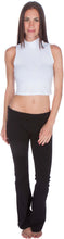 Charger l'image dans la galerie, Woman wearing a white mock neck sleeveless crop top and black pants, showcasing stylish casual fashion.