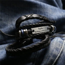Cargar imagen en el visor de la galería, Men's leather bracelet with engraved 'Together We Make a Difference' plaque on denim background, stylish and rugged accessory.