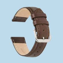 Cargar imagen en el visor de la galería, Brown leather watch band, 22mm, genuine Italian calfskin, semi-glossy finish, hand-stitched edges, silver buckle on blue background.