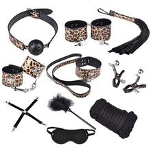 Cargar imagen en el visor de la galería, 10-piece leopard print vegan leather bondage set with cuffs, blindfold, ball gag and whip for BDSM play.