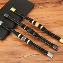 Cargar imagen en el visor de la galería, Woven leather rope stainless steel men's bracelet in elegant design, shown in black with silver and gold accents on wooden surface.