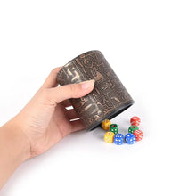 Cargar imagen en el visor de la galería, Hand holding Egyptian pattern brown leather rune dice cup with colorful dice.