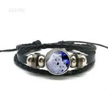 Cargar imagen en el visor de la galería, Handmade leather bracelet with wolf and moon design, featuring black braided leather and stainless steel details.