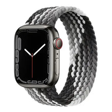 Load image into Gallery viewer, Black and white braided nylon elastic Apple Watch strap with watch, compatible with 38mm to 45mm sizes, shown on a silver case.