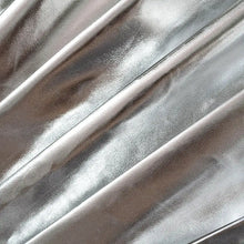 Cargar imagen en el visor de la galería, Close-up of pleated faux leather fabric in metallic silver for a mini skirt, showcasing the stylish and sophisticated texture.