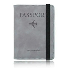 Cargar imagen en el visor de la galería, Gray leather passport holder with RFID blocking, featuring travel-themed embossing and elastic band for secure closure.