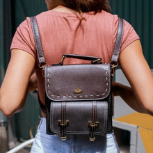 Load image into Gallery viewer, Bumblebee vegan leather backpack worn outdoors, showcasing sleek and professional design with a bee emblem on the flap.