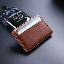 Cargar imagen en el visor de la galería, Premium leather magic wallet with card slots next to a perfume bottle, showcasing sleek and stylish everyday carry.