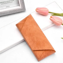Cargar imagen en el visor de la galería, Tan PU leather sunglasses case on white surface with pink flowers, featuring elegant design and compact storage for eyewear protection.