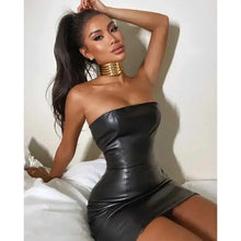 Cargar imagen en el visor de la galería, Woman wearing a chic faux leather dress, showcasing its sleek design and sophisticated silhouette, perfect for versatile style options.