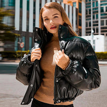 Load image into Gallery viewer, Woman wearing a stylish winter thick PU leather coat, perfect for staying warm and fashionable in cold weather.