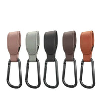 Cargar imagen en el visor de la galería, Set of five PU leather baby stroller hooks in various colors for organizing bags and toys on prams.