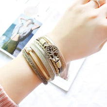 Cargar imagen en el visor de la galería, Vegan leather charm bracelet with pearls and magnet buckle, featuring a Life of Trees design, worn on a woman's wrist.