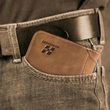 Cargar imagen en el visor de la galería, EliteFold leather wallet in a pocket, showcasing its compact design and premium style for everyday essentials management.