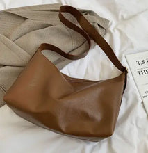 Cargar imagen en el visor de la galería, Retro luxury shoulder bag in brown vegan PU leather, elegantly styled on a fabric background.