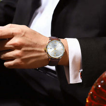 Cargar imagen en el visor de la galería, Luxury men's quartz watch with vegan leather strap, worn with a suit, showcasing elegance and sophisticated design.